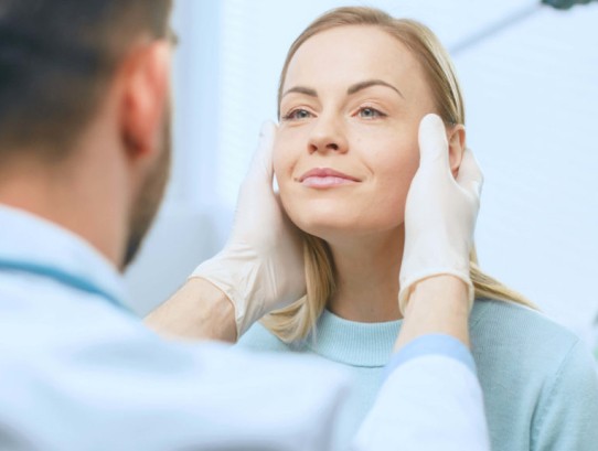 doctor examining patient's face